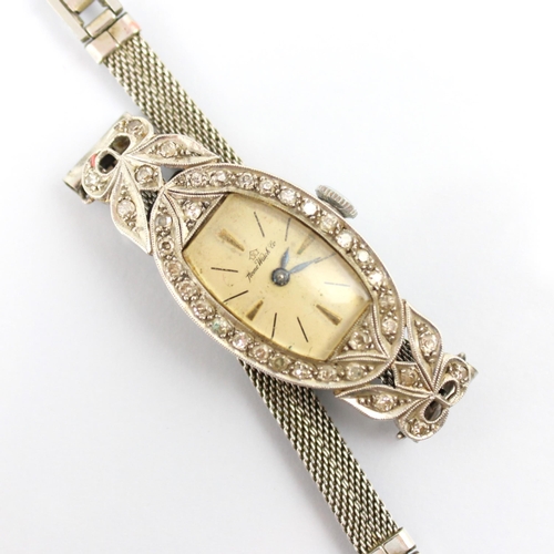 60 - An early 20th century 'Home Watch Co' diamond cocktail watch, the cream tonneau shaped dial with bat... 