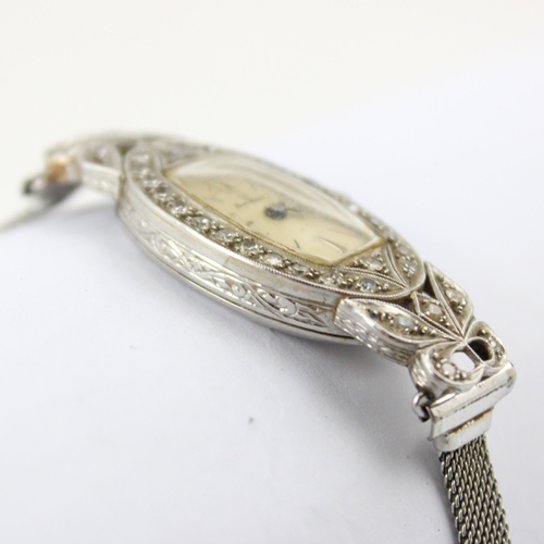 60 - An early 20th century 'Home Watch Co' diamond cocktail watch, the cream tonneau shaped dial with bat... 