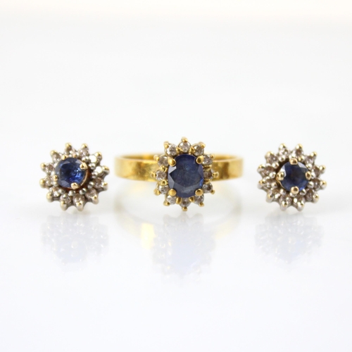 64 - A yellow metal untested sapphire and diamond cluster ring, the oval cut untested sapphire within sur... 