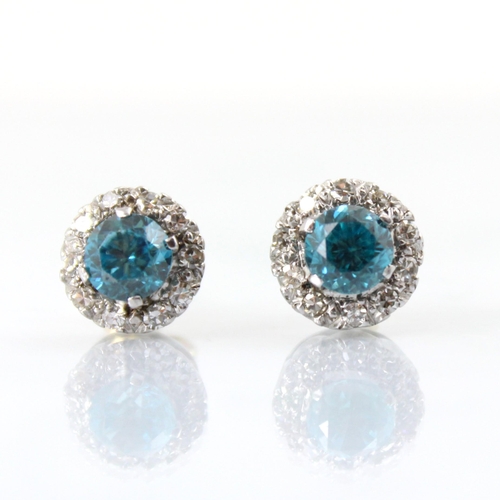 65 - A pair of blue zircon and diamond cluster earrings, the round cut blue zircons within a surround of ... 