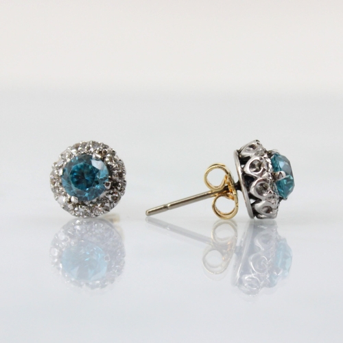 65 - A pair of blue zircon and diamond cluster earrings, the round cut blue zircons within a surround of ... 