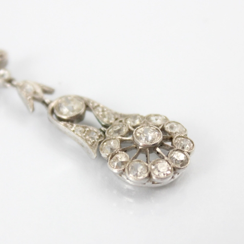 68 - A pair of early 20th century diamond drop earrings, the stylised flowerhead set with eleven round cu... 