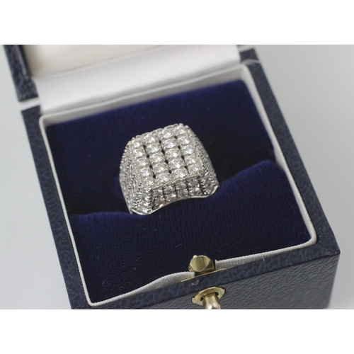 69 - An Italian white gold diamond set cocktail ring, the square shaped head with round cut diamonds set ... 