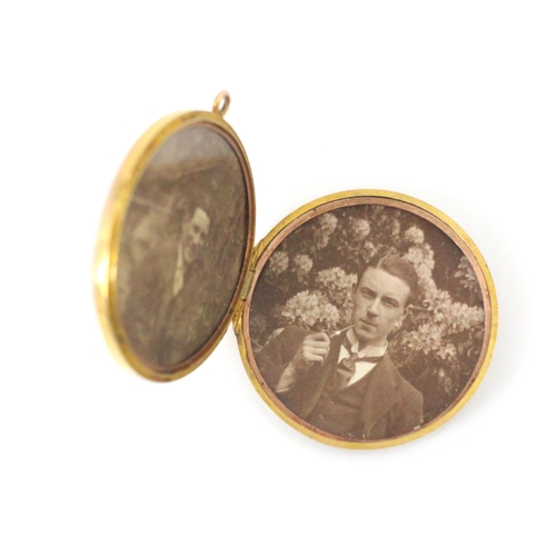 74 - An early 20th century 9ct yellow gold pendant/locket, the plain polished circular locket opening to ... 