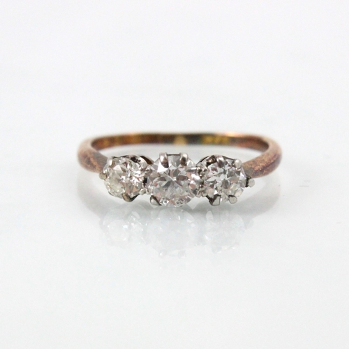 75 - A 20th century diamond three stone ring, the central old cut diamond with smaller diamond to each si... 