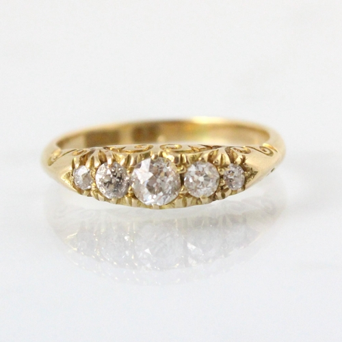 78 - A late 19th century diamond five stone ring, the five graduated old cut diamonds within yellow metal... 