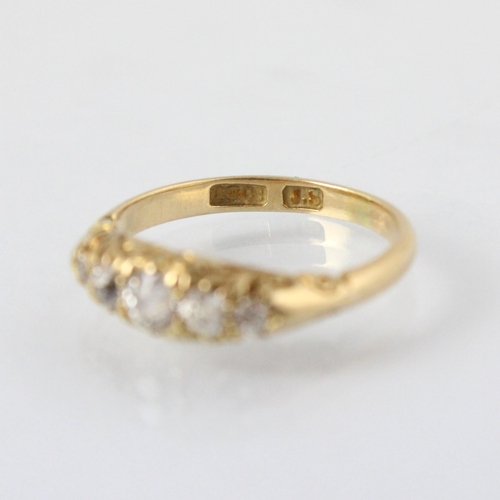 78 - A late 19th century diamond five stone ring, the five graduated old cut diamonds within yellow metal... 