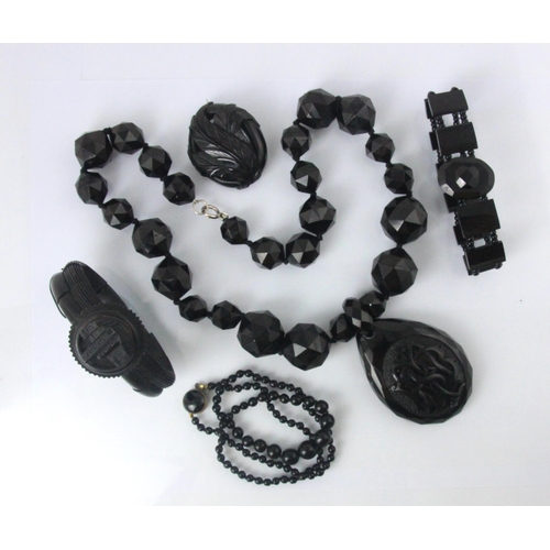 79 - A selection of 'Whitby jet' coloured jewellery, including a necklace suspending a tear drop shaped p... 