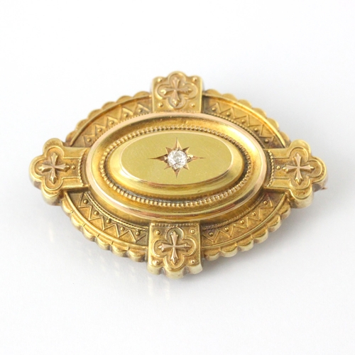 80 - A late 19th/early 20th century diamond set yellow metal brooch, the raised oval centre set with an o... 