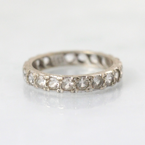 81 - An 18ct white gold white sapphire full eternity ring, the twenty round cut white sapphires within wh... 