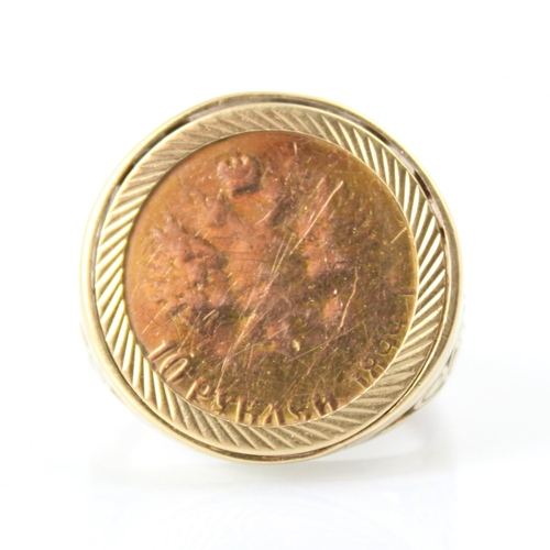 89 - A Russian coin mounted dress ring, the '10 rubels' coin within stylised openwork shoulders and plain... 