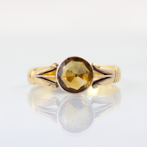 92 - A 22ct yellow gold wedding band, converted to a citrine set dress ring, the circular cut citrine wit... 