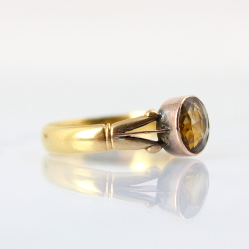 92 - A 22ct yellow gold wedding band, converted to a citrine set dress ring, the circular cut citrine wit... 