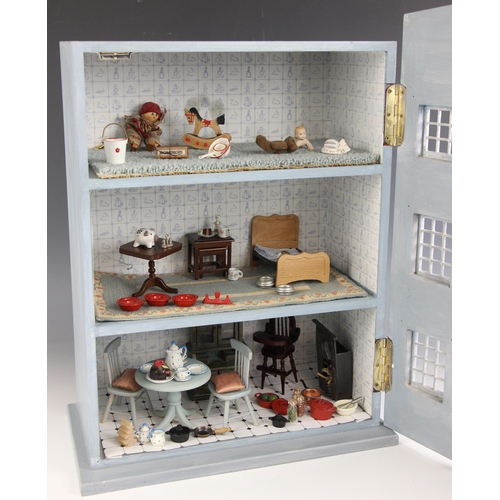 364 - A handmade dolls house, 20th century, converted from a wall cupboard and modelled as a three storey ... 