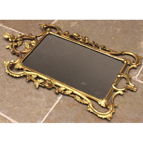 453 - A George III giltwood wall mirror, the rectangular mirrored plate set within a 'C' scroll and foliat... 