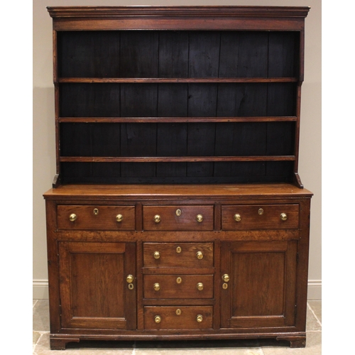 454 - A late George III Welsh oak dresser, the plate rack with a moulded cornice and plain frieze over thr... 