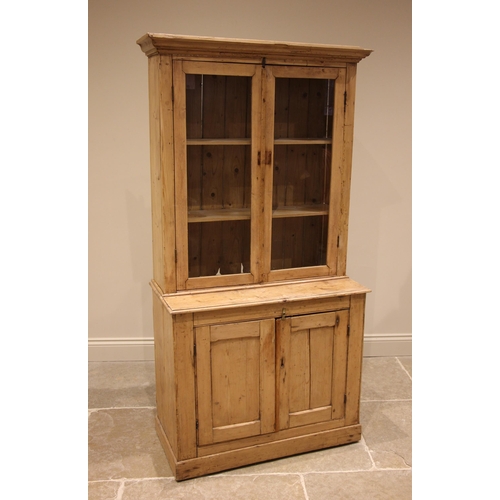 480 - A Victorian pine glazed kitchen dresser, the moulded cornice over a pair of glazed doors opening to ... 