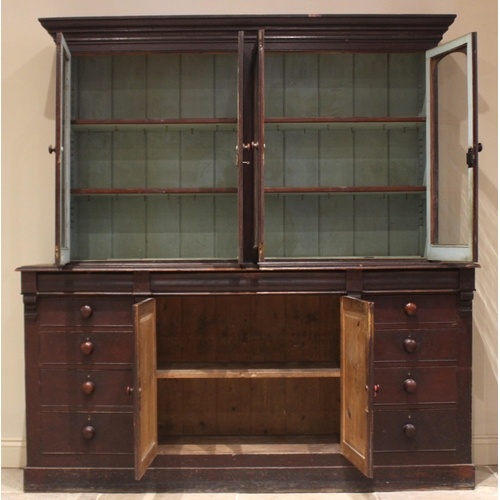 487 - A Victorian stained pine glazed bookcase/housekeepers cupboard, the moulded cornice over two pairs o... 