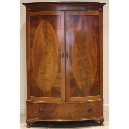 490 - An Edwardian mahogany bowfront double wardrobe, the moulded Greek pattern cornice over a frieze inla... 