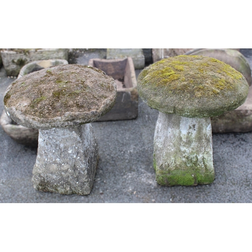 519 - A near pair of 19th century sandstone staddle stones, each with a domed cap upon a pyramidal shaped ... 