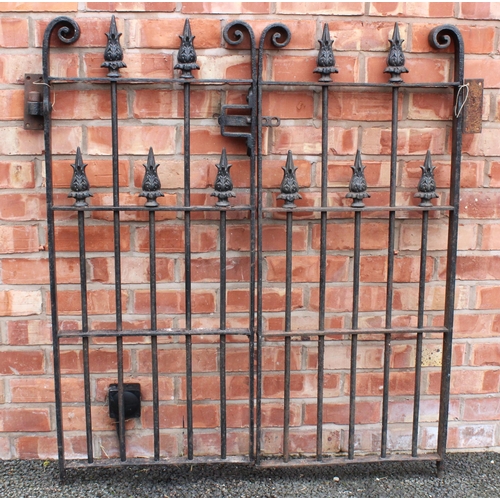 530 - A pair of wrought iron garden gates, the iron work frame with scrolled terminals enclosing plain upr... 