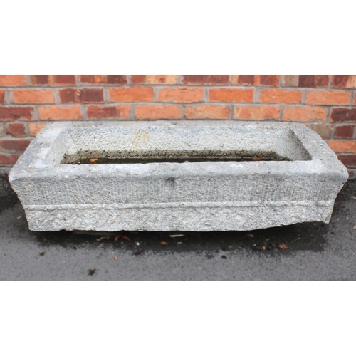 533 - An 18th/19th century granite trough, of rectangular form, with drain hole to the interior, scored ve... 