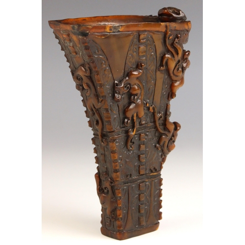 325 - A carved horn libation cup, late 19th/early 20th century, the archaistic shaped vase with conforming... 