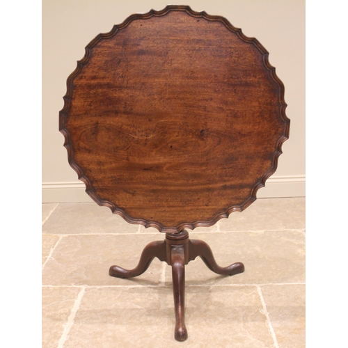 433 - A George III mahogany tilt top tripod table, the circular top with a moulded pie crust rim upon a cu... 