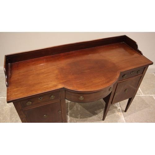 460 - A 19th century mahogany sideboard, possibly Irish, the galleried top of break arch form outlined wit... 