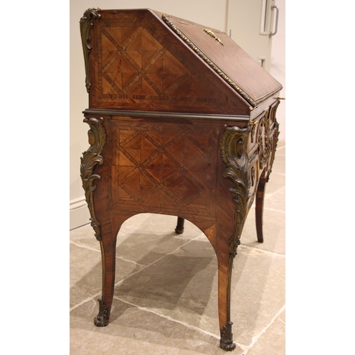 461 - A French kingwood and walnut lattice parquetry bureau, circa 1860, applied with ormolu mounts and ba... 