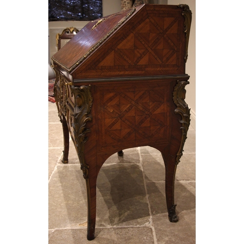 461 - A French kingwood and walnut lattice parquetry bureau, circa 1860, applied with ormolu mounts and ba... 