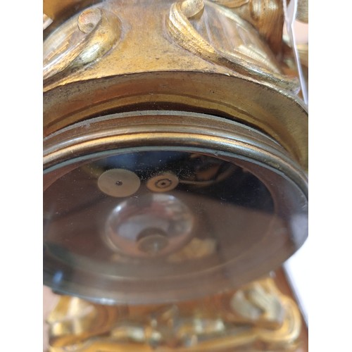 421 - A Rococo revival gilt metal eight day mantel clock, late 19th century, the case of cast scrolled aca... 