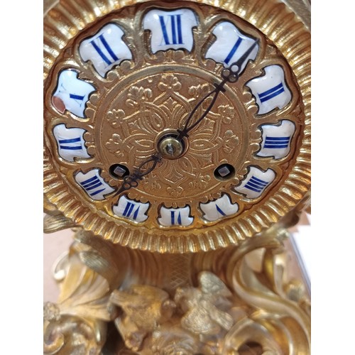 421 - A Rococo revival gilt metal eight day mantel clock, late 19th century, the case of cast scrolled aca... 