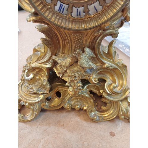 421 - A Rococo revival gilt metal eight day mantel clock, late 19th century, the case of cast scrolled aca... 