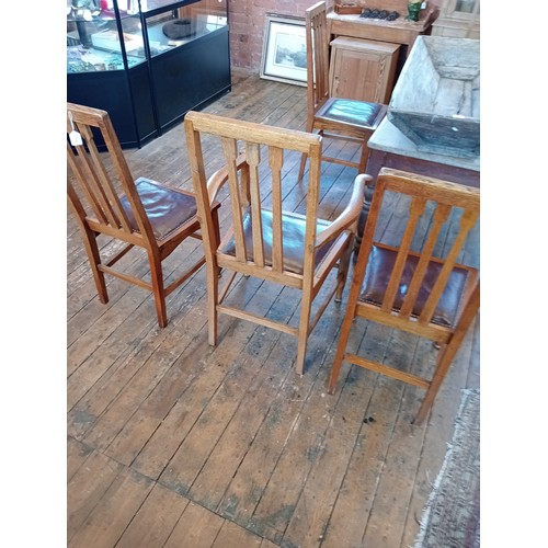 500 - A set of six golden oak Arts and Crafts style dining chairs, early 20th century, each with an angula... 