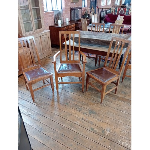 500 - A set of six golden oak Arts and Crafts style dining chairs, early 20th century, each with an angula... 