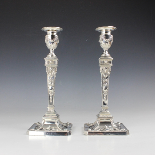 10 - A pair of Edwardian silver candlesticks, William Hutton & Sons Ltd, London 1902, the urn shaped scon... 