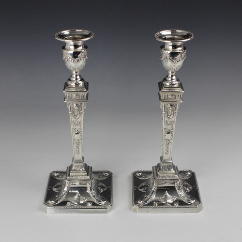 10 - A pair of Edwardian silver candlesticks, William Hutton & Sons Ltd, London 1902, the urn shaped scon... 