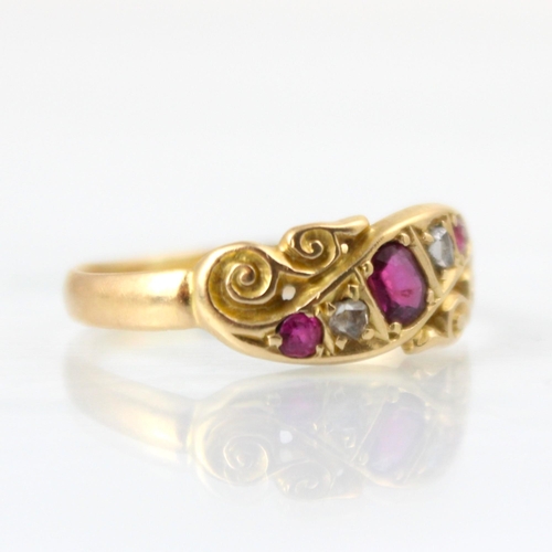 104 - An early 20th century yellow metal ring, the red stone set ring with rose cut diamond detail, set wi... 