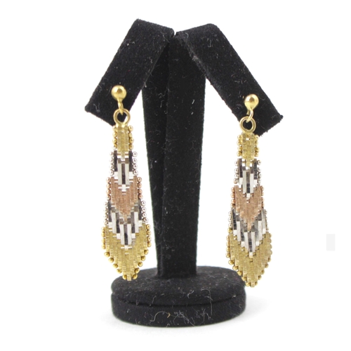 105 - A pair of gold coloured mesh work earrings, the tri coloured arrow shaped earrings with textured and... 