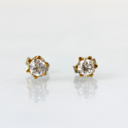 108 - A pair of diamond stud earrings, the round cut diamonds (one an old cut diamond) within claw setting... 