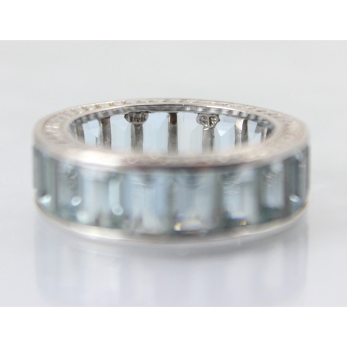 109 - A late 20th century untested aquamarine full eternity ring, the eighteen rectangular cut blue stones... 