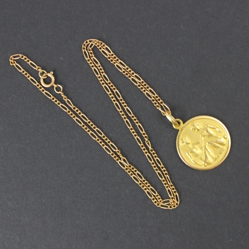 116 - A yellow metal ‘Gemini’ style pendant, the circular pendant stamped to reverse ‘750’ upon an associa... 