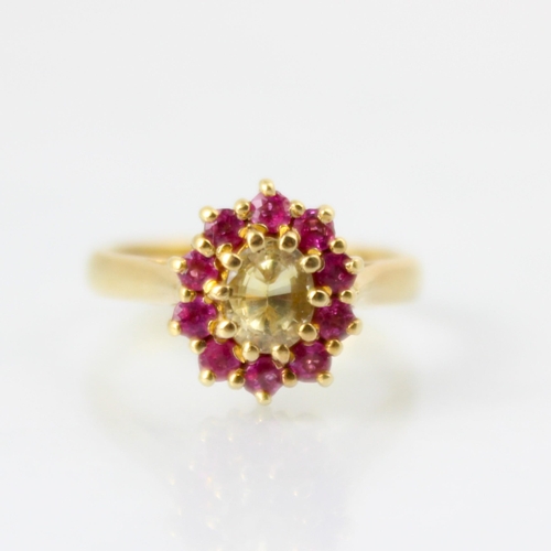 121 - A bespoke untested yellow sapphire and pink spinel cluster ring, the central oval cut untested yello... 