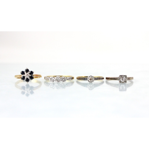 122 - A group of four rings, including an early 20th century diamond solitaire, the old cut diamond in a w... 