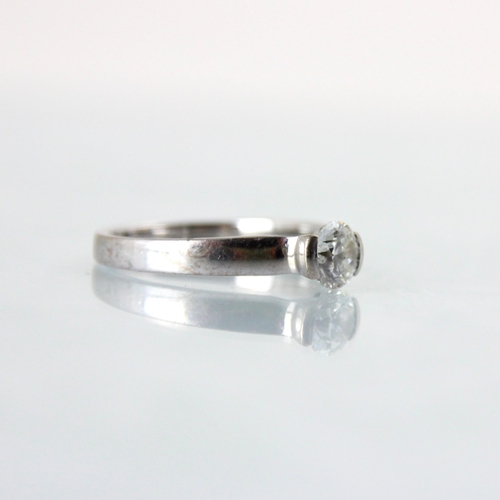 123 - An 18ct white gold diamond solitaire ring, the central brilliant cut diamond within partial rub over... 