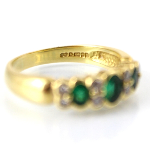 126 - A mid 20th century untested emerald and diamond ring, the central oval cut untested emerald with two... 