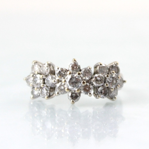 127 - A 18ct white gold diamond triple cluster ring, the central round cut diamond within surround of six ... 