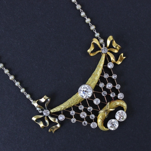 128 - An early 20th century Belle Epoque diamond and seed pearl necklace, the central old cut diamond with... 