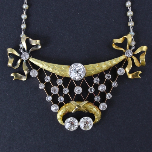 128 - An early 20th century Belle Epoque diamond and seed pearl necklace, the central old cut diamond with... 